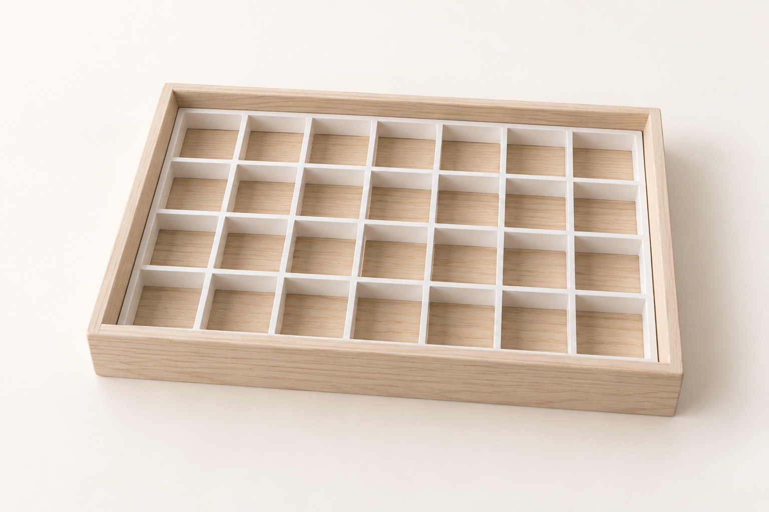 White grid fitted in a rectangular light-wood drawer